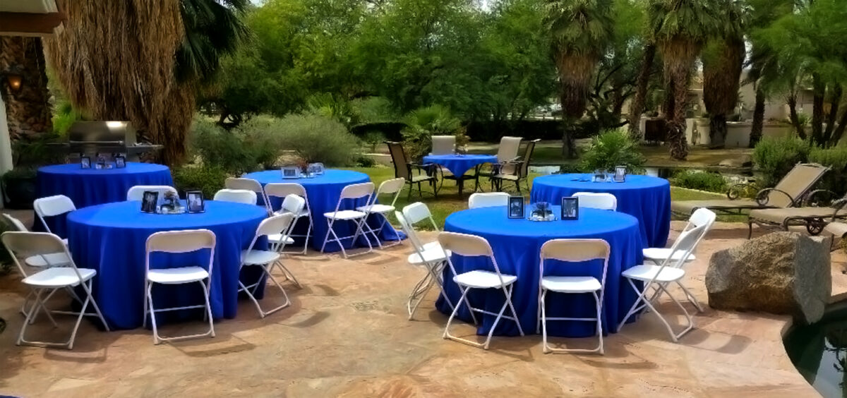 So many table and chairs decorated in an open field